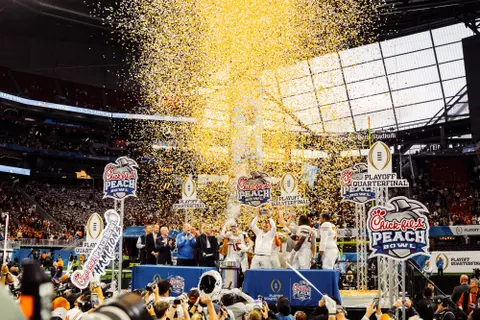 Texas football coaches and players in Peach Bowl confetti