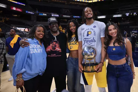 INDIANAPOLIS, INDIANA - MAY 31: Myles Turner #33 of the Indiana Pacers celebrates with the Bob Cousy Trophy and his family after the 125-108 win against the New York Knicks in Game Six of the Eastern Conference Finals of the 2025 NBA Playoffs at Gainbridge Fieldhouse on May 31, 2025 in Indianapolis, Indiana. NOTE TO USER: User expressly acknowledges and agrees that, by downloading and or using this photograph, User is consenting to the terms and conditions of the Getty Images License Agreement. (Photo by Justin Casterline/Getty Images)