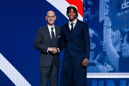 NEW YORK, NEW YORK - JUNE 25: Tre Johnson (R) shakes hands with NBA commissioner Adam Silver (L) after being drafted sixth overall by the Washington Wizards during the first round of the 2025 NBA Draft at Barclays Center on June 25, 2025 in the Brooklyn borough of New York City. NOTE TO USER: User expressly acknowledges and agrees that, by downloading and/or using this photograph, user is consenting to the terms and conditions of the Getty Images License Agreement. (Photo by Sarah Stier/Getty Images)