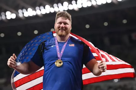 TOKYO, JAPAN - SEPTEMBER 13: Gold medallist, Ryan Crouser of Team United States, poses for a photo with the national flag following the the Men's Shot Put Final on day one of the World Athletics Championships Tokyo 2025 at National Stadium on September 13, 2025 in Tokyo, Japan. (Photo by Hannah Peters/Getty Images)