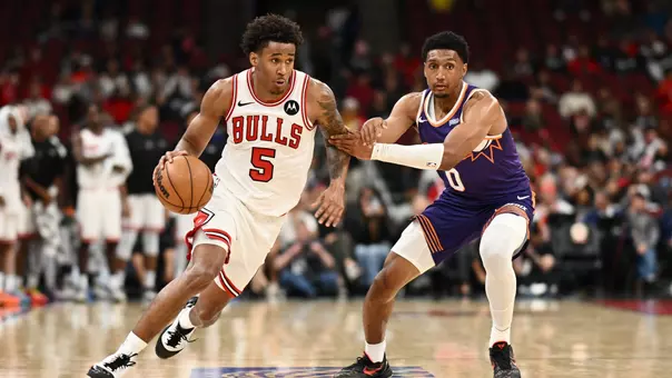 CHICAGO, ILLINOIS - OCTOBER 07: Dailyn Swain #5 of the Chicago Bulls dribbles the ball as Ryan Dunn #0 of the Phoenix Suns defends during the second half of the preseason game at the United Center on October 07, 2026 in Chicago, Illinois. NOTE TO USER: User expressly acknowledges and agrees that, by downloading and or using this photograph, User is consenting to terms and conditions of the Getty Images License Agreement. (Photo by Daniel Bartel/Getty Images)