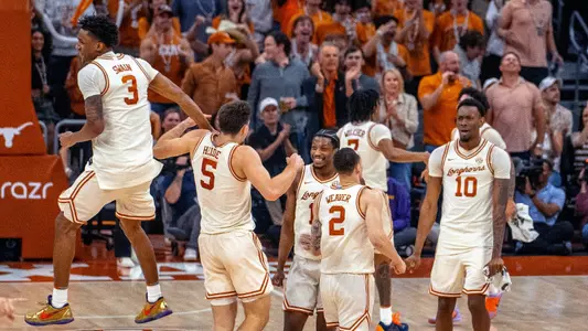 Men's Basketball players celebrate at timeout vs LSU