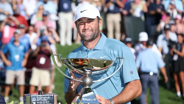 ATLANTA, GEORGIA - AUGUST 30: Scottie Scheffler of the United States lifts the trophy after winning the final round of the TOUR Championship 2026 at East Lake Golf Club on August 30, 2026 in Atlanta, Georgia. (Photo by Kevin C. Cox/Getty Images)
