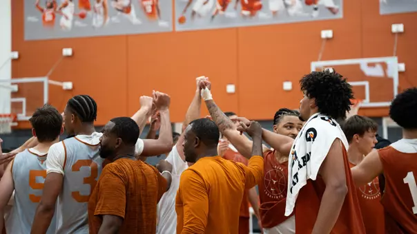 men's basketball end of practice team huddle image