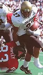 Colorado tailback Cortlen<br>Johnson is tackled by<br>Texas Tech defenders<br>Kyle Shipley and<br>Keith Cockrum, rear,<br>during the first<br>half Saturday.