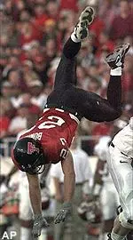 Texas A&M quarterback<br>Randy McCown looks<br>to pass as Texas<br>Tech's Reagan Bownds<br>flies by during<br>the second quarter.