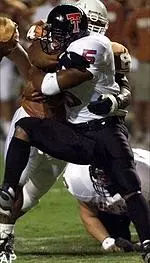 Running back Sammy<br>Morris is hit by<br>Texas defender Casey<br>Hampton during the<br>first quarter Saturday.