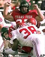 Tech quarterback Kliff Kingsbury drives forward for a 1-yard touchdown as running back Shaud Williams watches in the 38-28 Red Raider win Saturday.