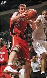 Andy Ellis battles with<br>the Aggies' Paul Jacobs<br> for the rebound.