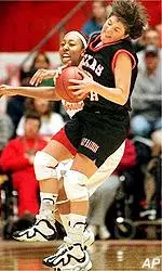 Rene Hanebutt is fouled by<br>Nebraska's Naciska Gilmore<br>during first half action.