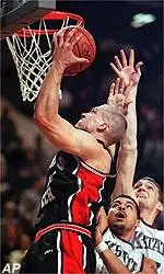 Cliff Owens takes a shot<br>around two KSU defenders<br>during the first half.
