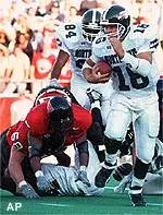 Texas Tech defensemen<br>give chase to North<br>Texas quarterback Jason<br>Attaway in the second<br>quarter.