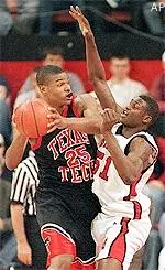 Johnny Phillips looks for an open man while Nebraska's Louis Truscott puts the pressure on in the first half of Tech's 70-67 loss Wednesday night.