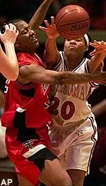 Texas Tech forward Keitha Dickerson tries to block a pass from Oklahoma guard Laneishea Caufield during the first half of the Big 12 women's game in Norman, Okla. Saturday.