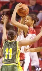 Texas Tech's Plenette Pierson (54) looks to pass the ball against Southeastern Louisiana's Tamika Williams Tuesday night, Dec. 19, 2000, in the United Spirit Arena in Lubbock, Texas