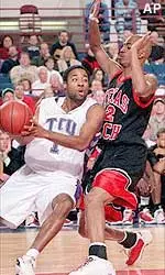 Texas Christian guard Nucleus Smith (1) looks to pass past Texas Tech forward Ronald Hobbs in the first half.