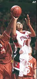 Plenette Pierson gets around Texas' Roshunda Johnson to go up for a shot during the first half of the 73-44 Lady Raider win Thursday.