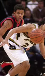 Texas Tech's Andre Emmett, left, and Missouri's Wesley Stokes, right, fight for a loose ball.