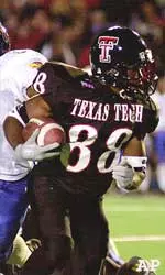 Texas Tech wide receiver Nehemiah Glover runs past the attempted tackle of Kansas' Leo Etienne (6) during the second quarter.