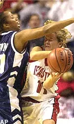Texas Tech's Candi White (11) passes the ball around Rice guard LaToya Brown (20) in the first half.