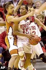 Texas Tech's Jia Perkins (15) is defended by Texas guard Tai Dillard, left.