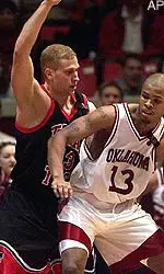Texas Tech forward Cliff Owens (13) tries to stop Oklahoma forward Aaron McGhee (13) from taking a two point shot.