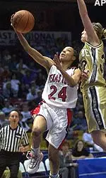 Texas Tech's Katrisa O'Neal goes past Purdue's Katie Douglas on her way to the basket during the first half of the NCAA Women's Mideast Regional.