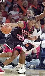 Texas Tech's Jamal Brown drives past Oklahoma State's Victor Williams in the first half at the Big 12 basketball tournament Thursday.