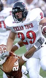 Texas Tech's Toby Shain tries to get away from Texas' Phillip Geiggar during the first quarter.