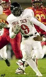 Texas Tech's Taurean Henderson (19) runs from Iowa State's Atif Austin (21) and Tyson Smith (1) after making a reception during the second quarter, Saturday Oct. 12, 2002, in Ames, Iowa.