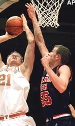 Texas's Jason Klotz tries to shoot over Texas Tech's Andy Ellis in the first half.