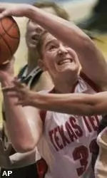 Jolee Ayers goes up for a shot between Missouri center Megan Roney and Angie Carter during the second half of their Big 12 tournament game Tuesday.