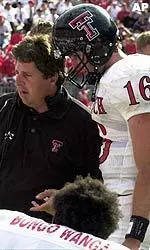 Texas Tech coach Mike Leach talks with quarterback Kliff Kingsbury during the fourth quarter.