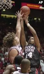Andre Emmett shoots over New Mexico defenders during the first half.