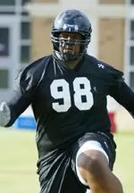 Redshirt freshman defensive tackle Ken Scott works through an agility drill during the first day of workouts Wednesday.