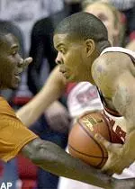 Andre Emmett goes head-to-head with Texas' Royal Ivey in the first half.