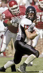 Sonny Cumbie tries to break a tackle against Oklahoma Saturday.