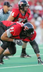 <b>Photo Courtesy of Picture Mann/Michael Strong. </b>Senior defensive end Adell Duckett lines up against Texas.