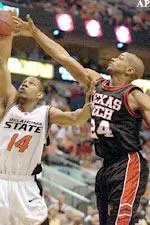 Ronald Ross and Oklahoma State's Joey Graham battle for the rebound during the first half.