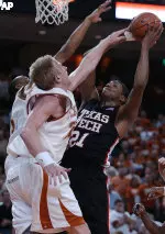 Devonne Giles shoots over the defense of Texas' Brad Buckman and Mike Williams during the first half.