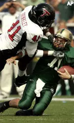 Baylor quarterback Shawn Bell, right, is chased down out of the pocket for a sack by Texas Tech's Sylvester Brinkley in the first half. (AP Photo/Tony Gutierrez)
