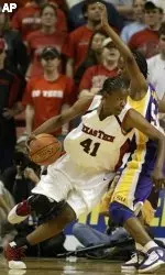 LaToya Davis drives around LSU's Ashley Thomas.