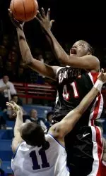 LaToya Davis takes a shot over Kansas' Aquanita Burras during the first half.