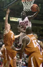 Martin Zeno goes up for a shot past Texas' Jason Klotz and Sydmill Harris.