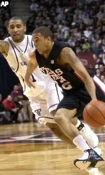 Jarrius Jackson drives up court defended by Texas A&M guard Acie Law in the first half.