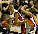 Judith Smith protects the ball as Oklahoma State's Nina Stone defends during the first half.