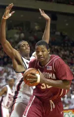 Oklahoma's Johnnie Gilbert is defended by Darryl Dorra during the first half.