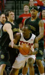 LucQuente White is defended by Baylor's Aaron Bruce, left, and Patrick Fields, right, during the first half. (AP Photo/ Joe Don Buckner)