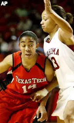 Texas Tech guard Erin Grant (14) drives the ball past Oklahoma guard Brittney Brown (33). (AP Photo/Ty Russell)