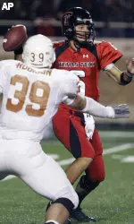 Graham Harrell passes under pressure from Texas' Ryan Bailey.